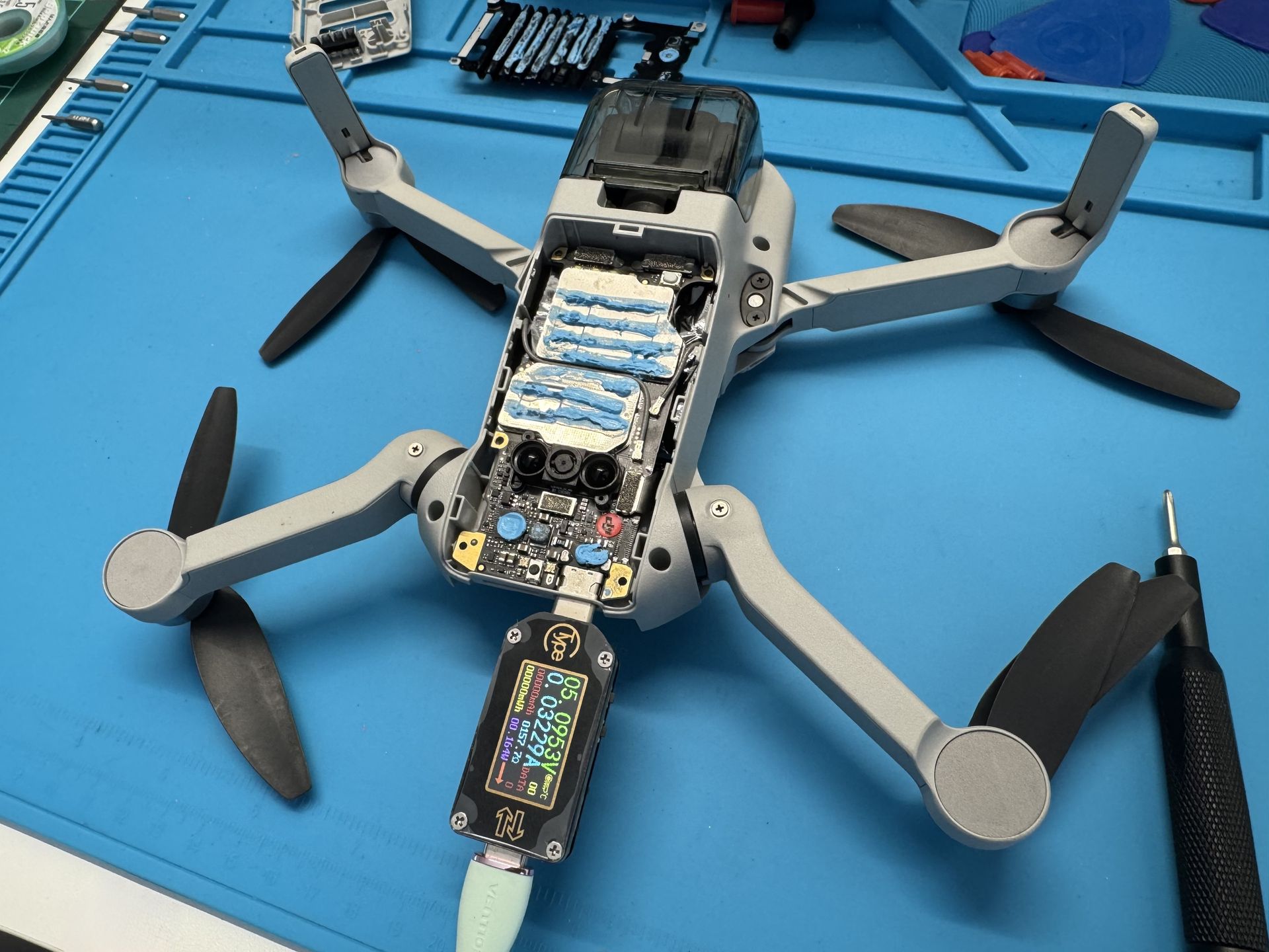 DJI mini 2 without top cover with charging cable connected