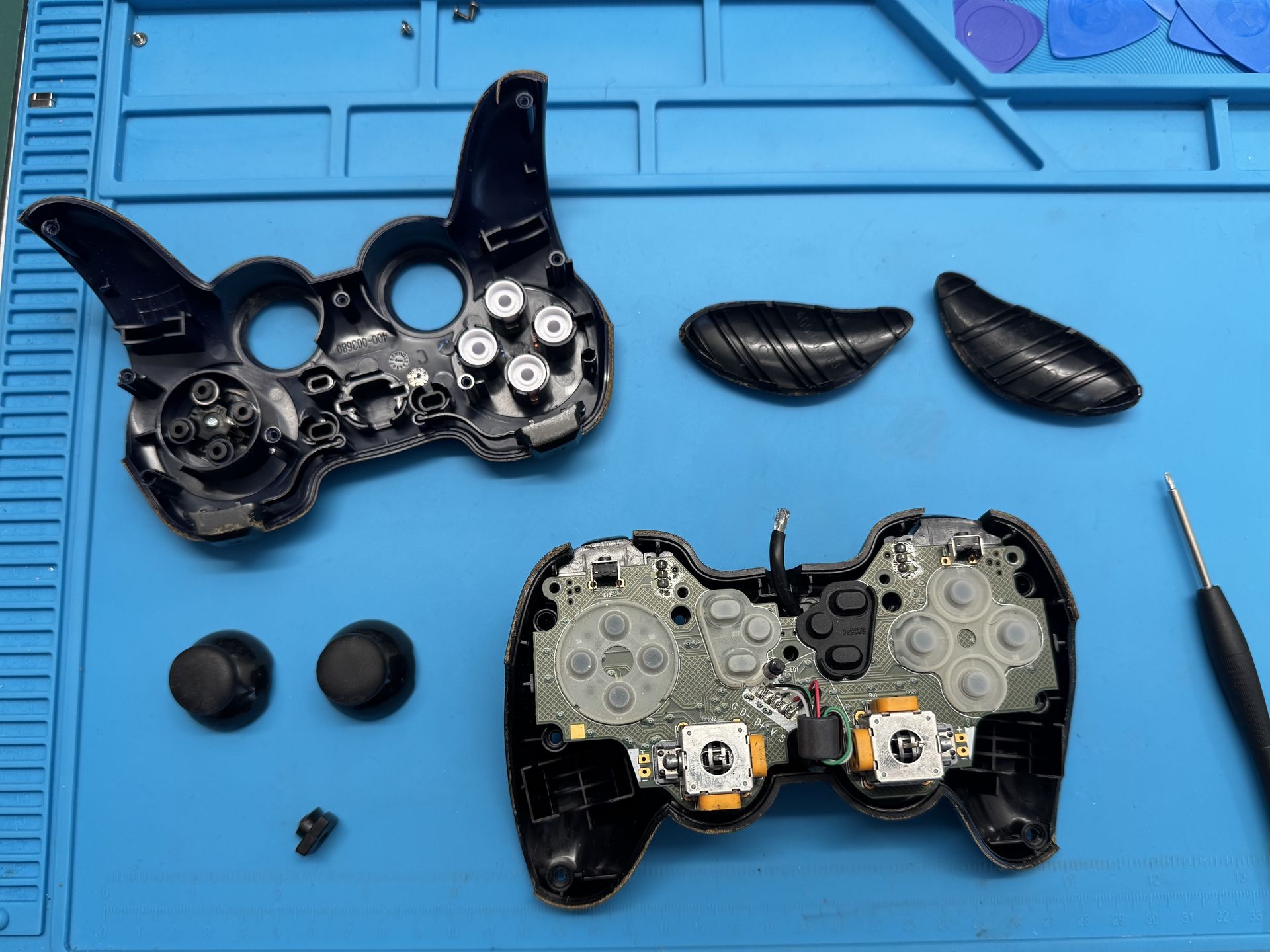 Disassembled Logitech game controller, top view to the motherboard.