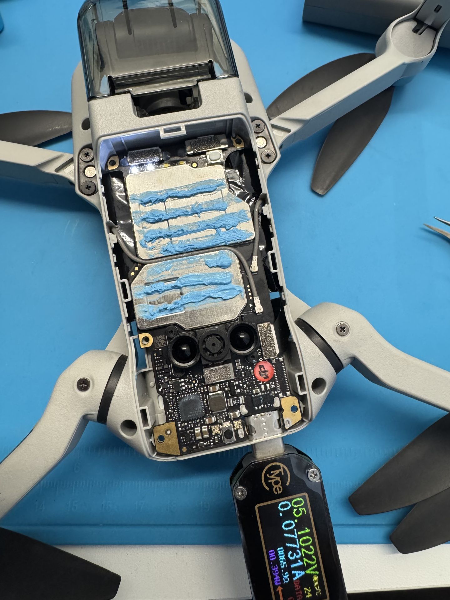 DJI mini 2 without top cover with charging cable connected